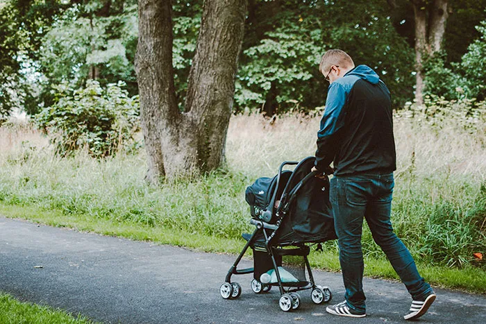 Man Pushing Baby on Stroller