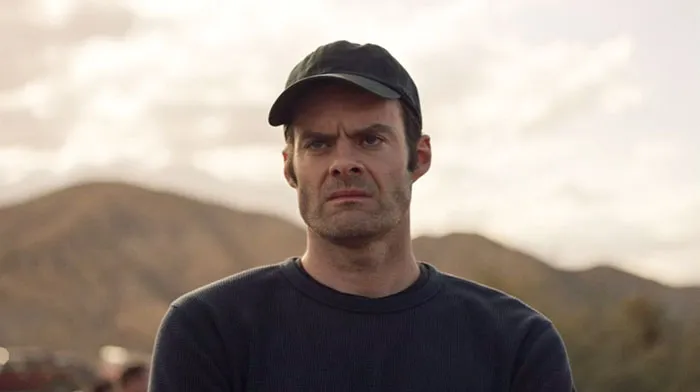Angry man with hat on looking at someone 