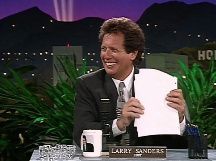 Nes reposter smiling with paper in his hands 