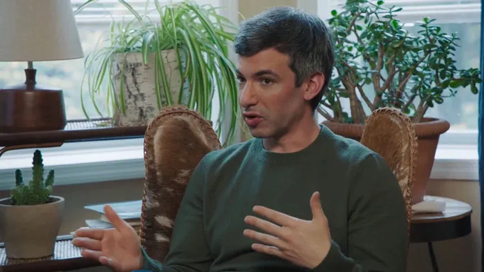 Man sitting and gesticulating while talking 