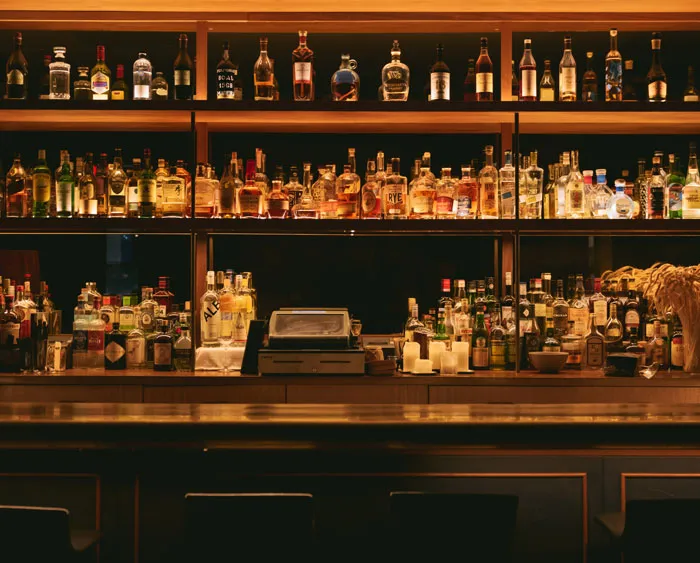 shelves with drinks near the bar table