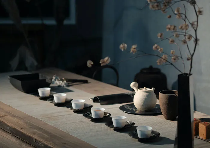 a long table with cups and and saucers