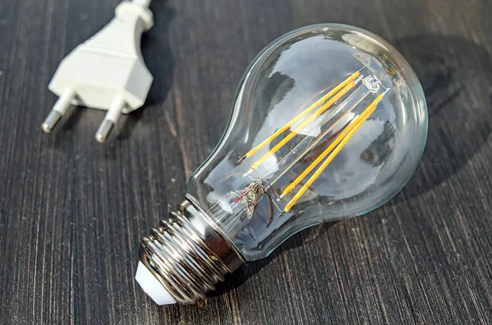 Close-up photography of light bulb on wooden table