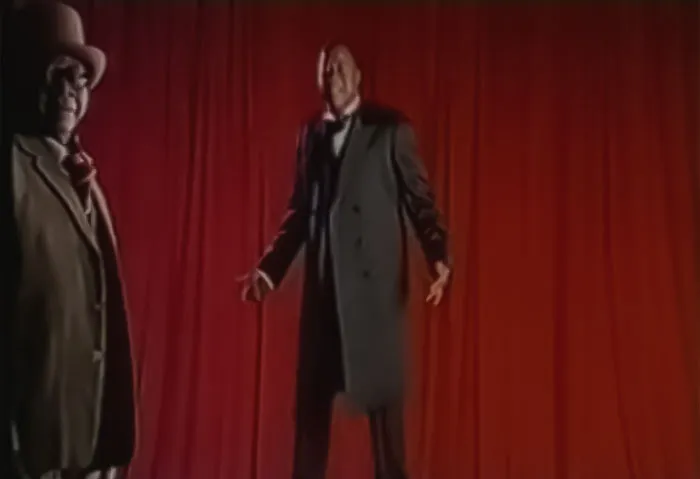 Image from Papa Wemba - Yolele, two man in classy wear performing in front of red curtains