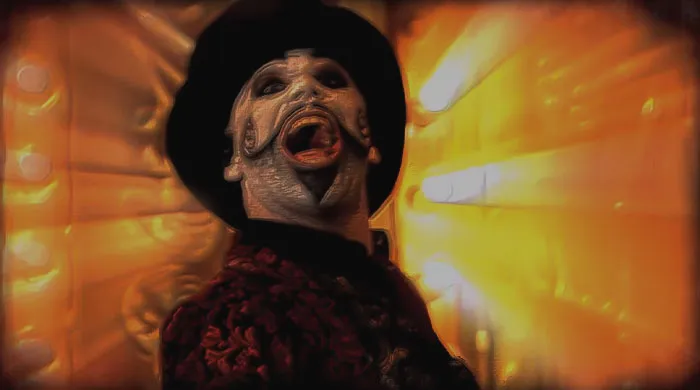 Image from SPACEMAK3R - Circus Spacemaker Metal Circus music video - a man with a black hat and face painted singing/screaming