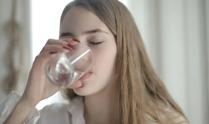 Woman Drinking Water From A Glass 