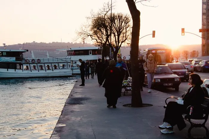 Multiple people sitting and walking in a dock 