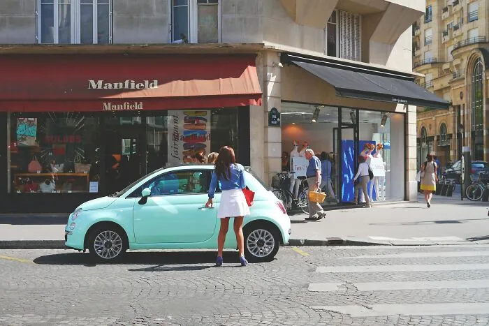 Woman getting in her car on the road 