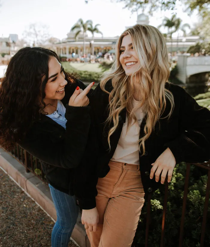 Friends wearing black jackets and laughing