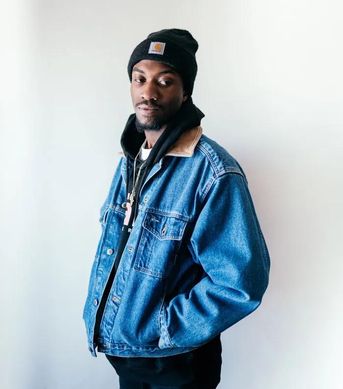 Man standing wearing blue jacket and hat