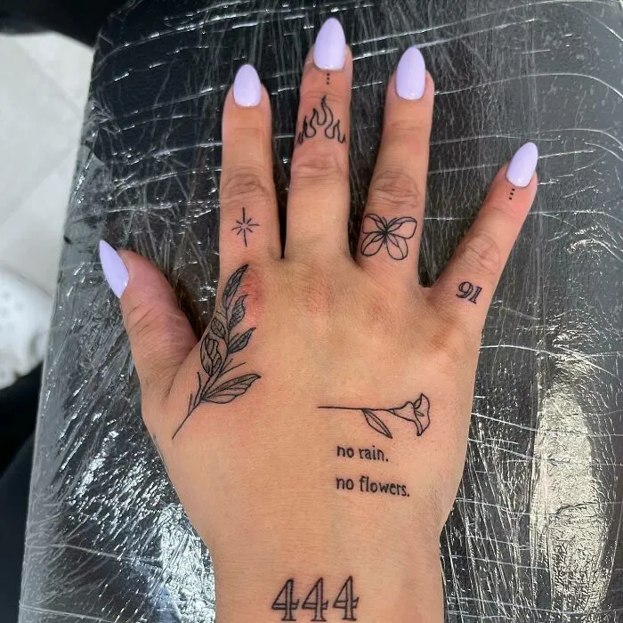 A collection of small hand tattoos featuring a butterfly, floral designs, numerals, and inspirational quotes.