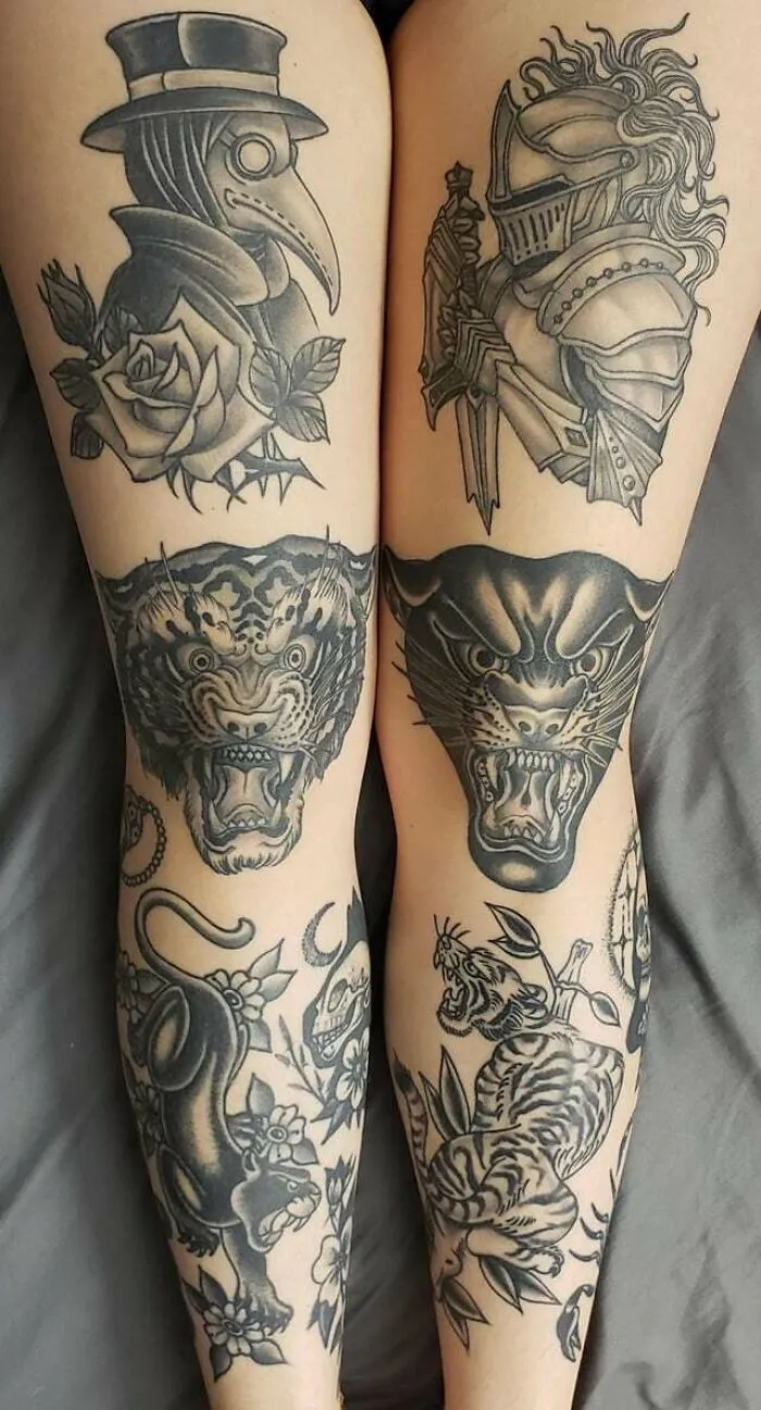 Knee tattoos featuring a knight and a plague doctor, alongside fierce animal designs on legs.
