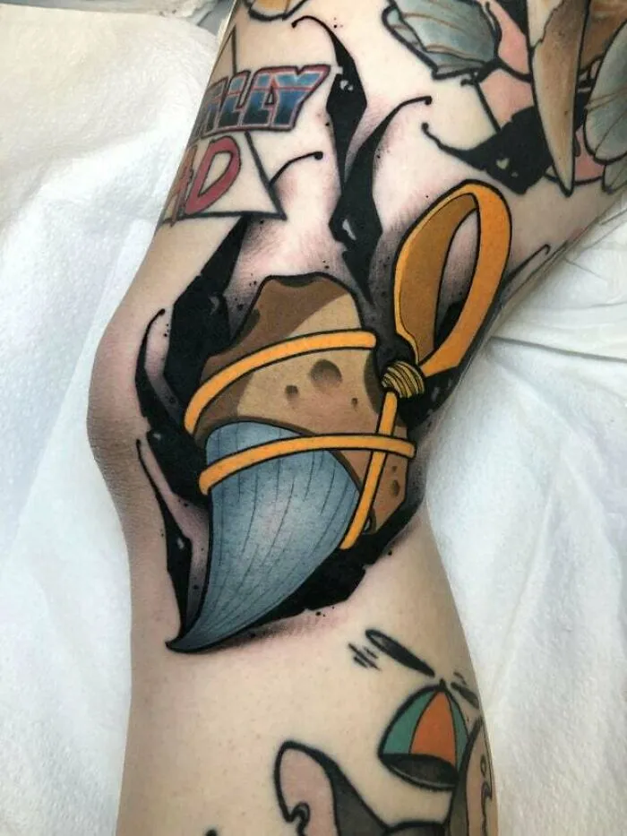Bold knee tattoos featuring a vibrant cartoon-style design with bright colors and sharp outlines on skin.