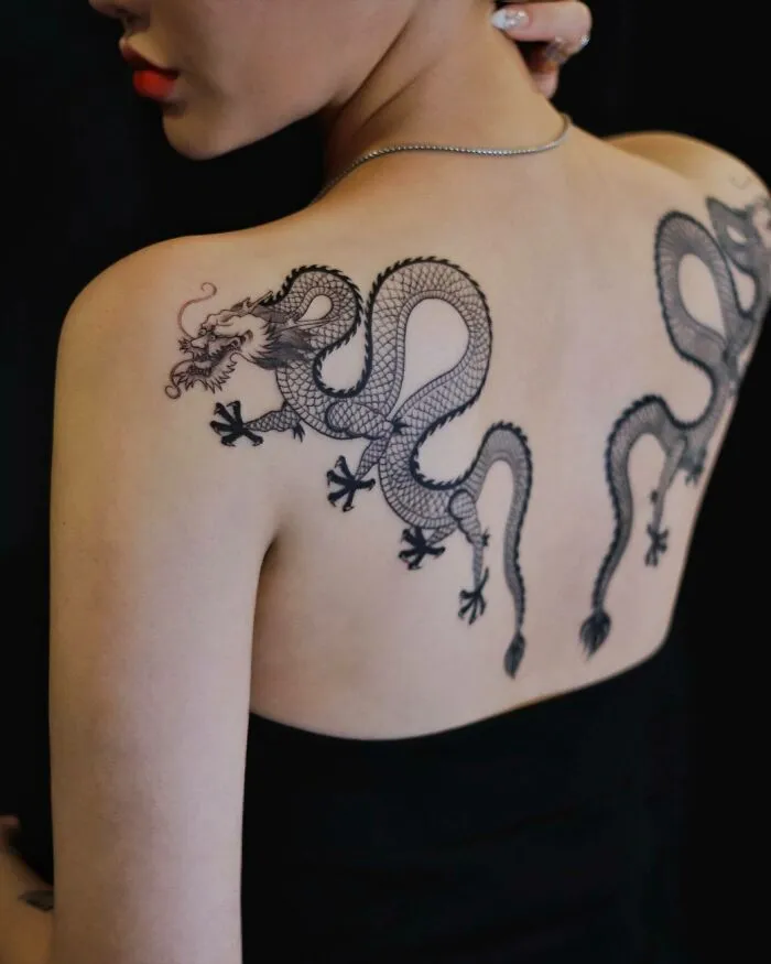 Intricate dragon tattoo design on a person's back, showcasing detailed scales and elegant curves.