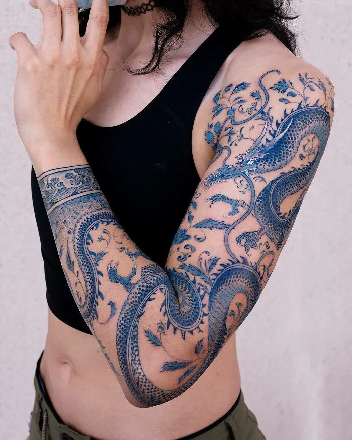 Blue Ink Dragon Sleeve Tattoo