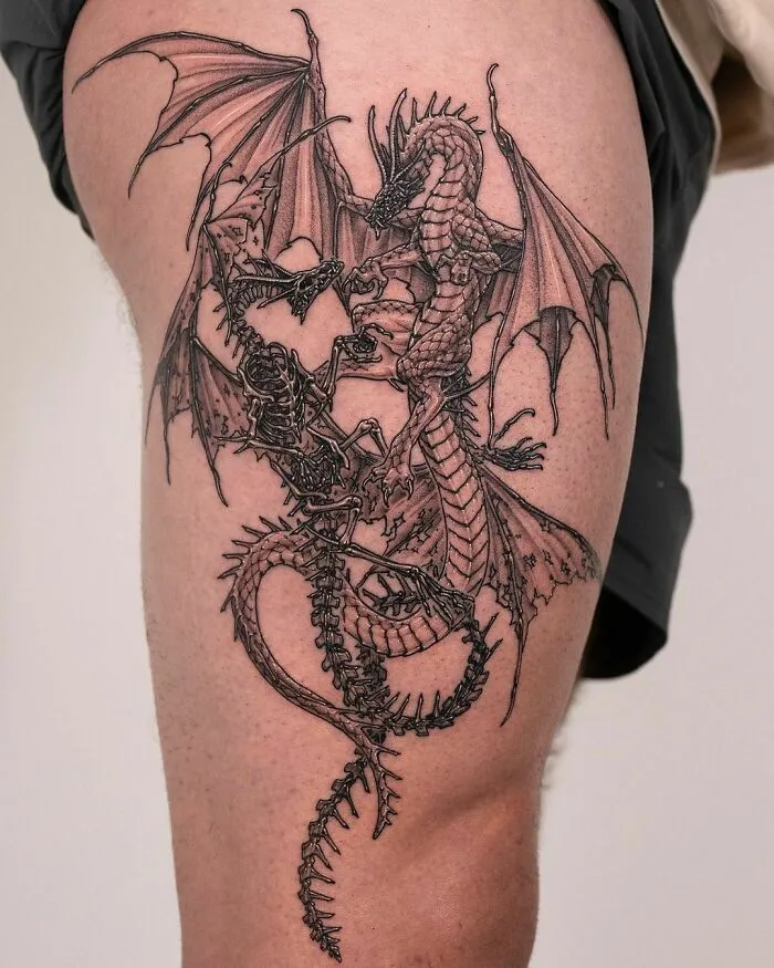 Intricate dragon tattoo design on a person's thigh, showcasing detailed wings and scales.