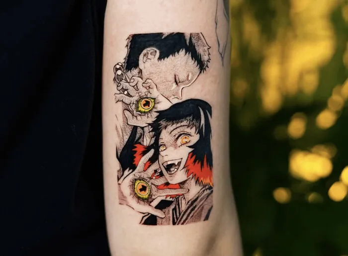 Anime tattoo featuring vibrant characters with expressive eyes on an arm.