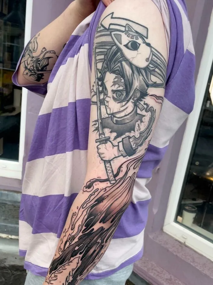 Anime tattoo on arm featuring a character with a sword and mask, in a detailed and dynamic style.