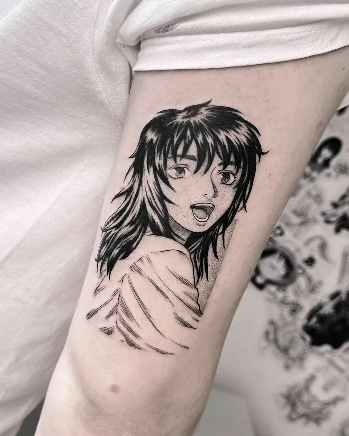 Anime tattoo of a character with long hair on someone's arm, showcasing detailed line work.