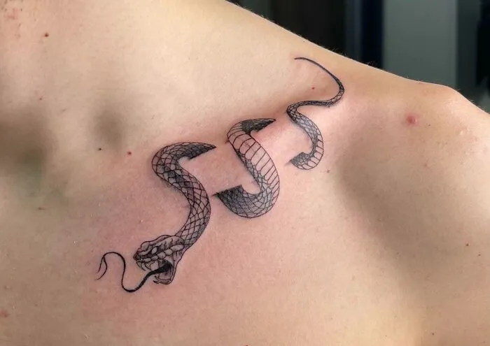 Snake tattoo design on a person's collarbone.