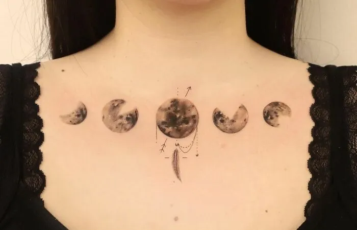 Collarbone tattoo with moon phases on woman's skin, showcasing elegant design.