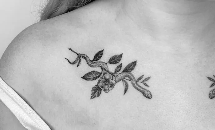 Snake and floral collarbone tattoo design for men and women.