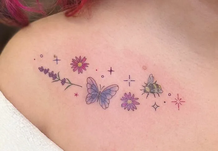 Colorful collarbone tattoo with a butterfly, flowers, and a bee, featuring delicate line art and soft shading.