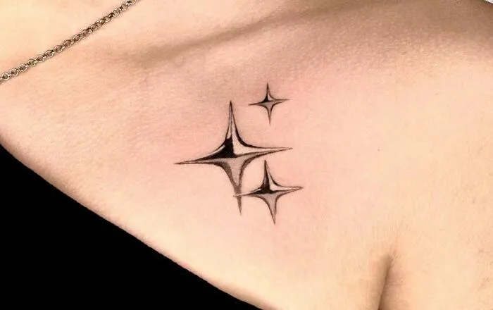 Collarbone tattoos of geometric stars on skin, showcasing trendy body art for men and women.