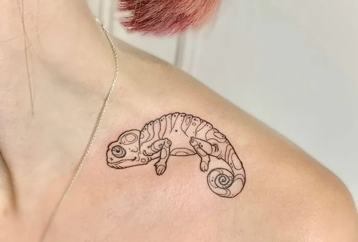 Chameleon collarbone tattoo on a person, showcasing creative body art for men and women.
