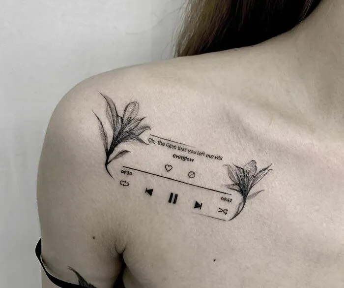 Delicate collarbone tattoo with floral design and music player symbols for men and women.