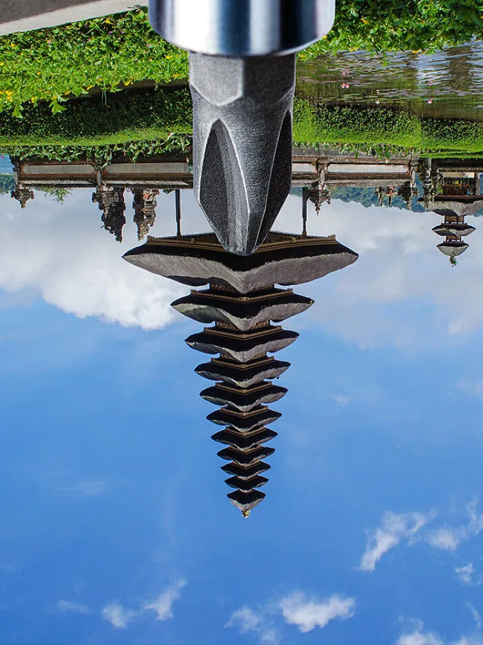 An upside-down image of a temple reflected in water, showcasing a unique perspective shift.