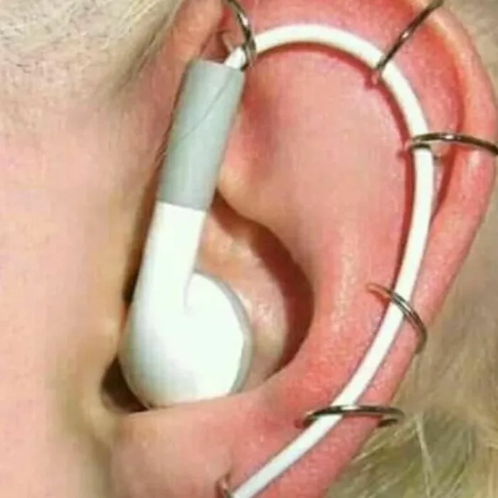 Cursed memes: an earpod oddly looped through an ear, creating a bizarre and unsettling visual effect.