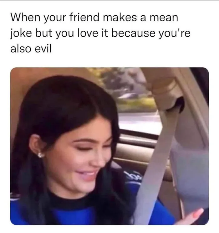 Woman laughing at a mean joke from her friend, capturing a hilarious meme moment.
