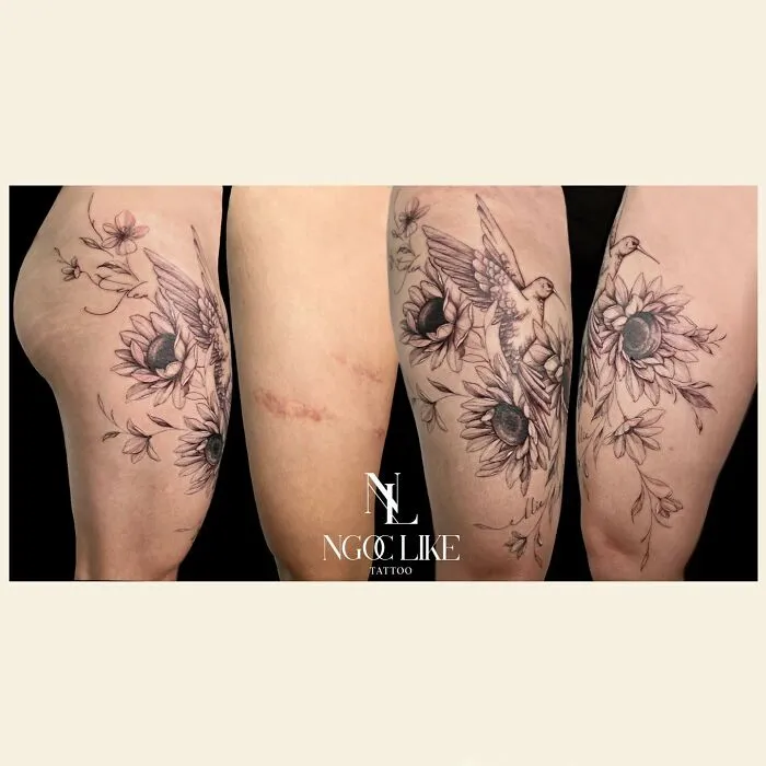 Tattoo artist covers scars with floral and bird design, showcasing skill and creativity.