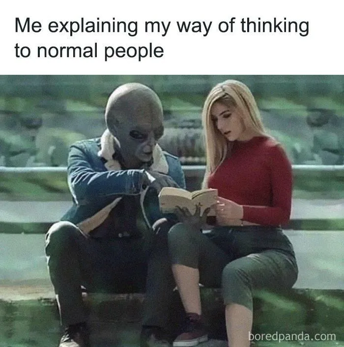 Alien wearing a jacket explaining a book to a woman in a red top, depicting relatable introvert memes humor.