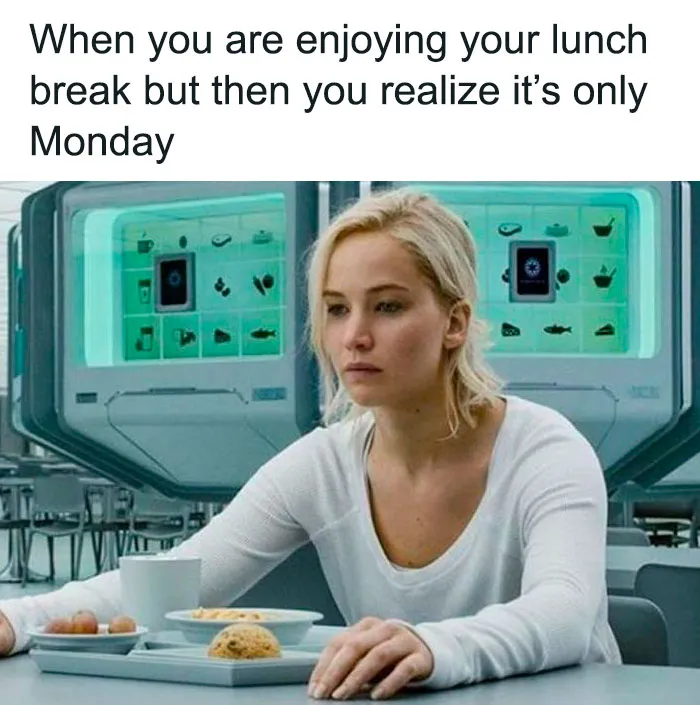 Woman looking unhappy during lunch in futuristic setting, depicting Monday memes vibe.