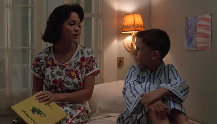 Mrs. Gump reading a bedtime story to young Forrest Gump, capturing a tender moment in Forrest Gump quotes context.