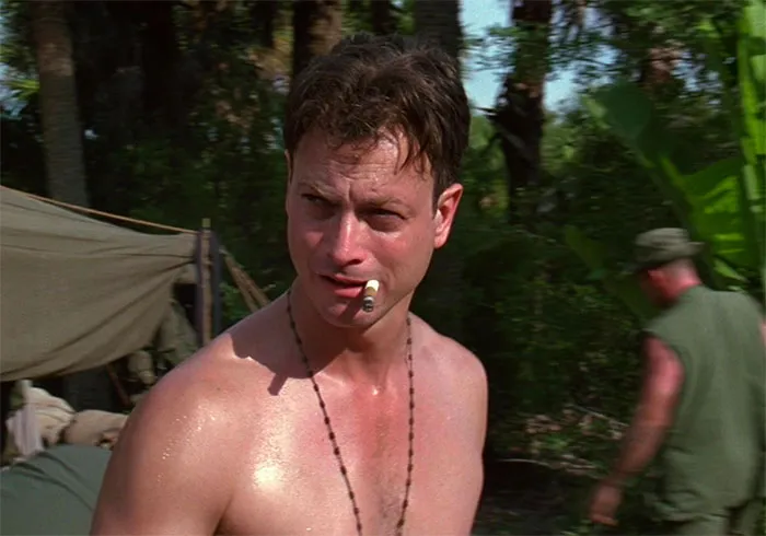 Lieutenant Daniel Taylor smoking a cigarette in a jungle setting, featured in Forrest Gump quotes collection scene.