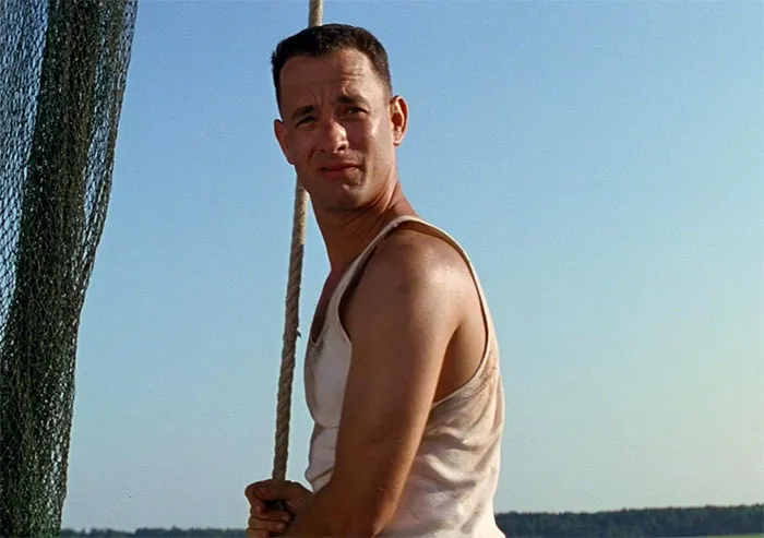 Forrest Gump sailing on a boat in a sleeveless shirt, capturing iconic Forrest Gump quotes moment on the water.