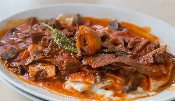 İskender, Turkey. Sliced Doner Meat Topped W/ Tomato Sauce Over Pieces Of Pita Served W/ Yogurt
