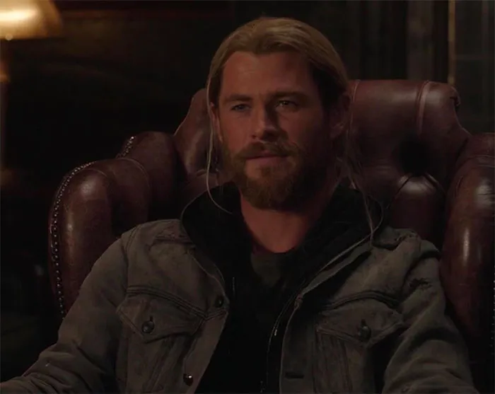 Thor is sitting in an armchair