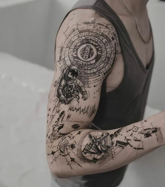 Black And Grey Astronaut Arm Tattoo