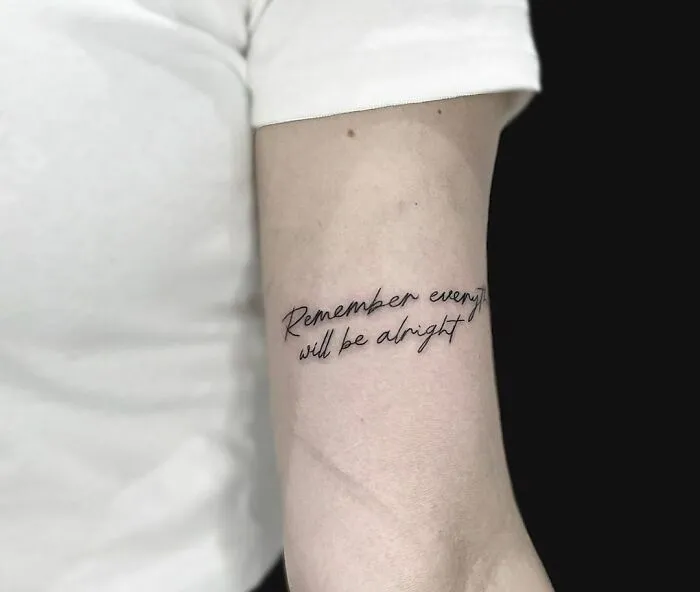 Tattoo on forearm reads "Remember everything will be alright," symbolizing mental health healing.