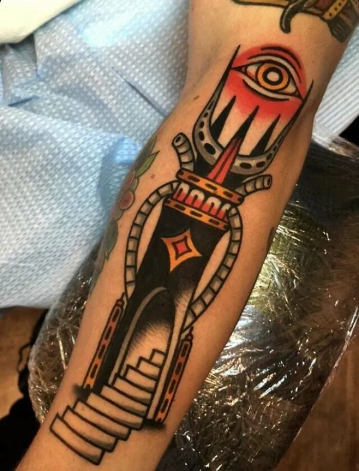 Lord of the Rings tattoo featuring Sauron's eye on an upper arm in vibrant colors.