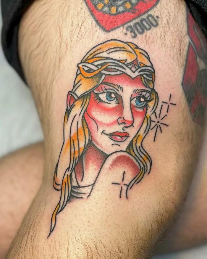Tattoo of an elf-like character on a person's leg, inspired by Lord of the Rings.