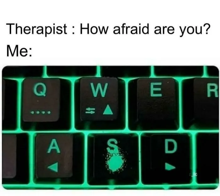 Meme of gaming keyboard with worn-out S key, highlighting gamer anxiety humor.