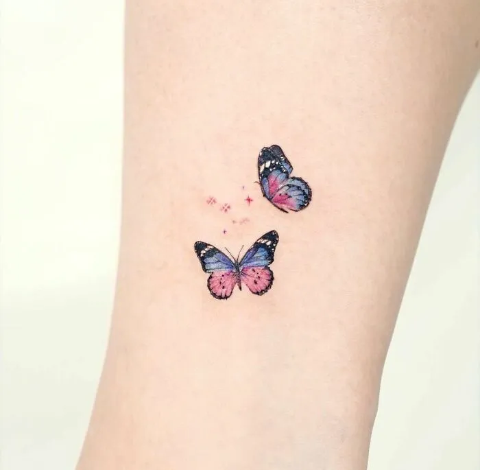 Colorful butterfly tattoo symbolizing mental health healing on the skin.