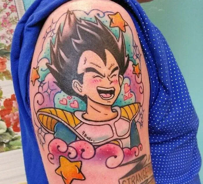 Anime tattoo featuring a joyful character with stars and colorful swirls on an arm.