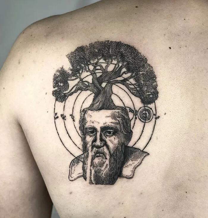Science tattoo featuring a tree growing from a historical figure's head, emphasizing knowledge and nature.