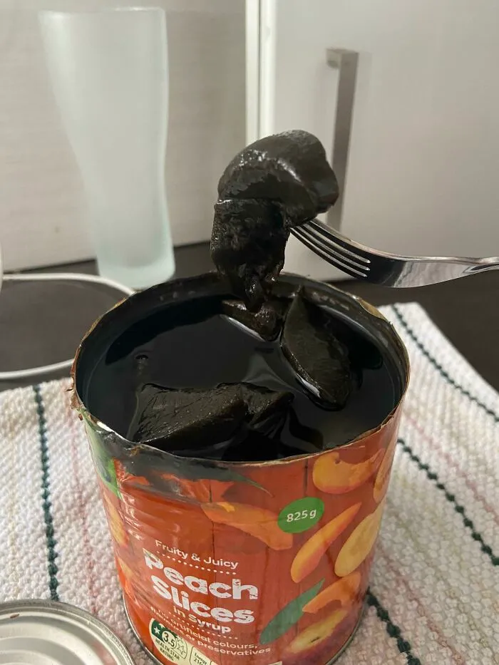 Opened A Can Of Peaches And They Were Black And Smelt Like Fish??